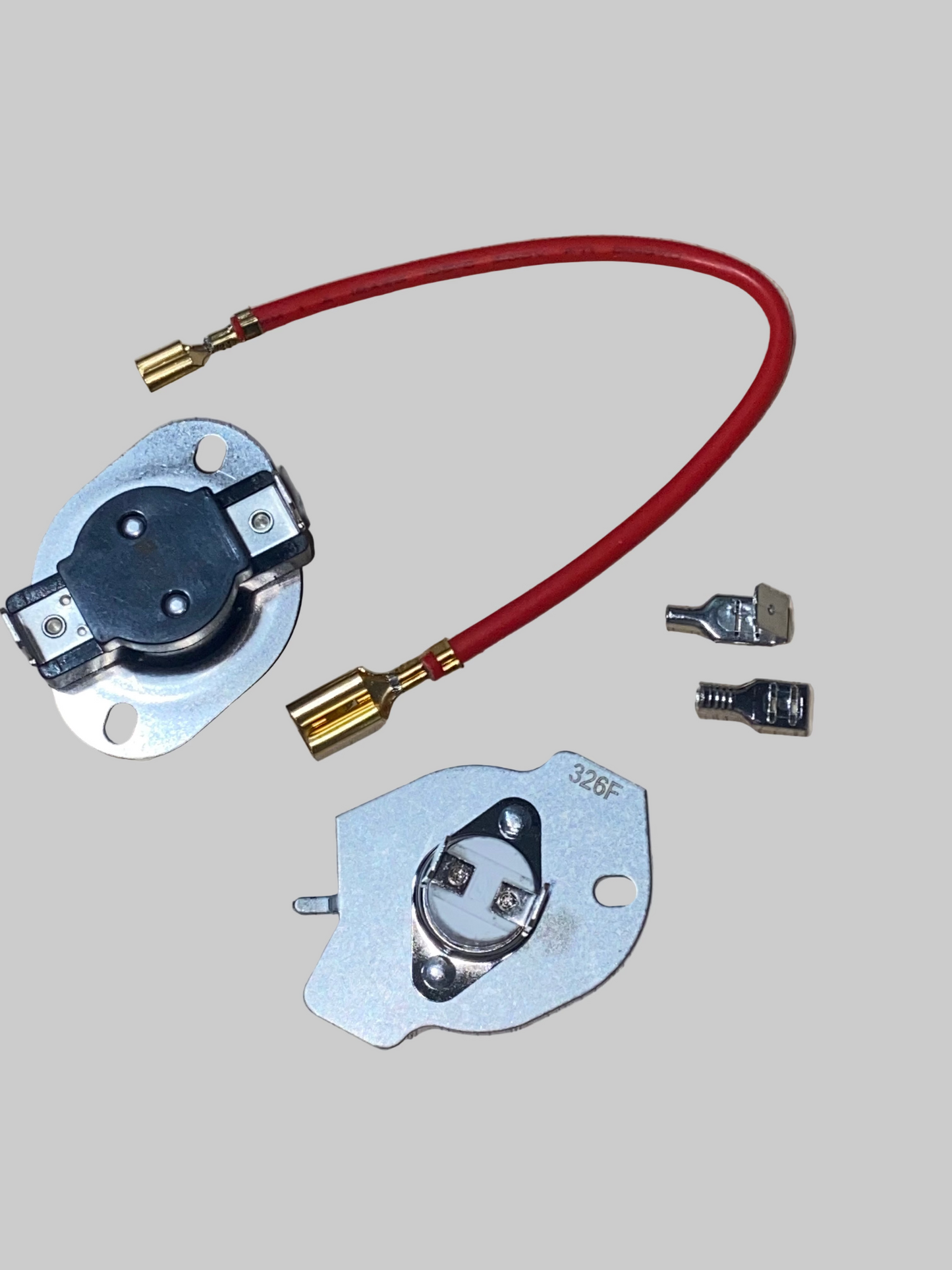 Electrical components including a red wire and metal connectors on a wooden surface